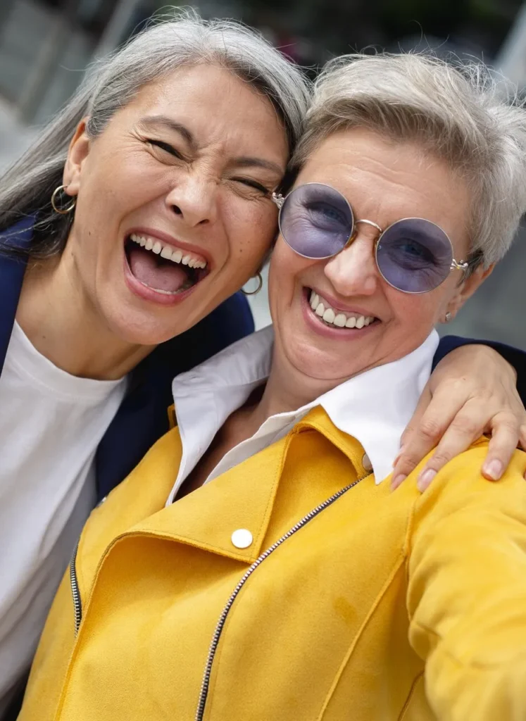 Two happy senior woman laughing sincerely